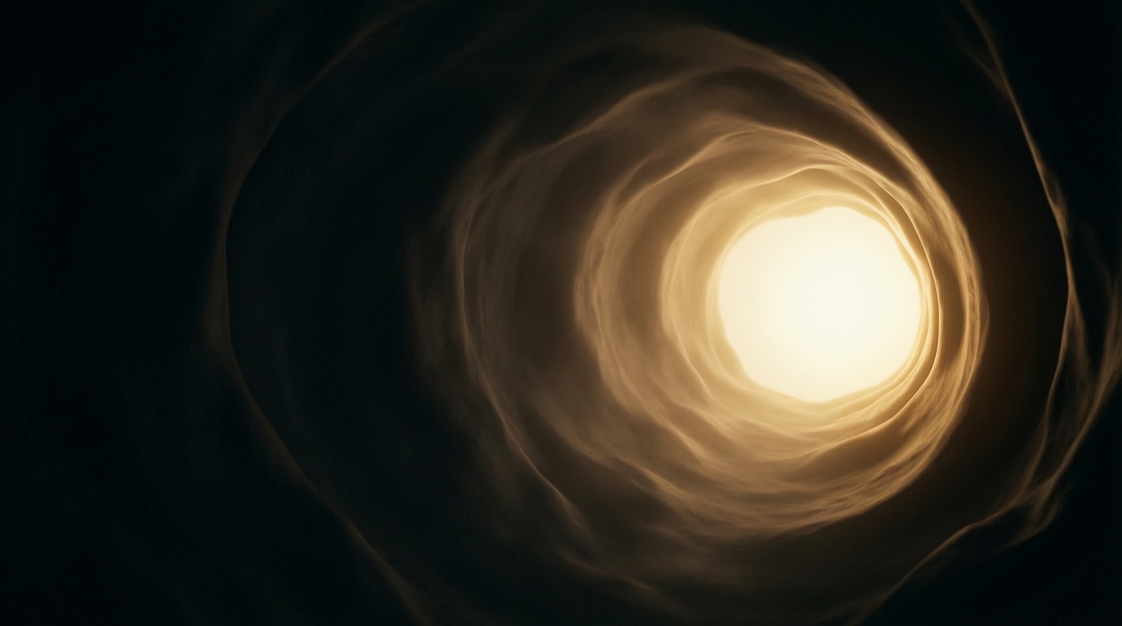 A dark passage opening into a warm glow of light in the distance
